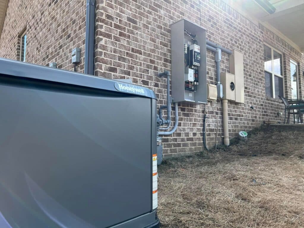 Honeywell standby generator installed beside a brick home